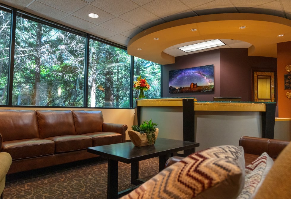 Dental office waiting room with a painting and fresh flowers