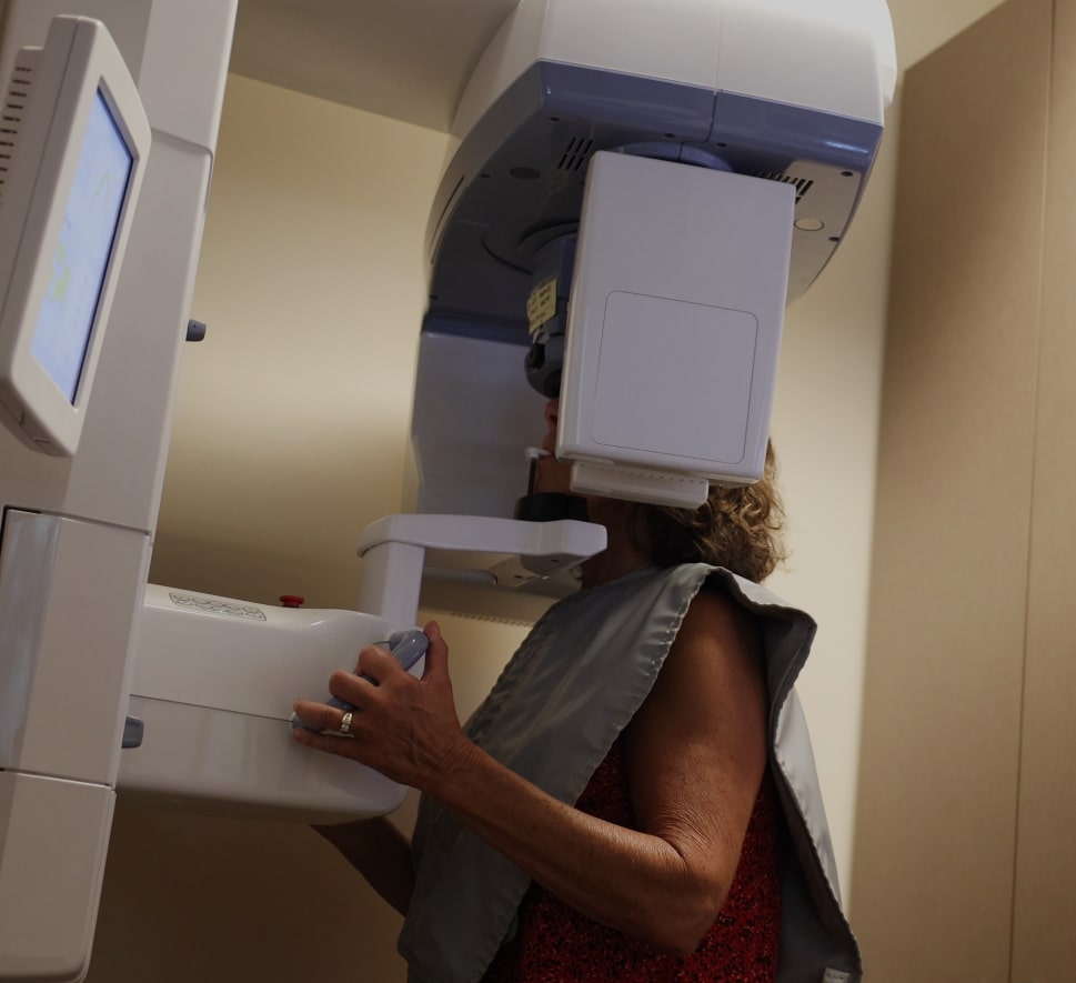 A woman undergoing a dental X-ray examination