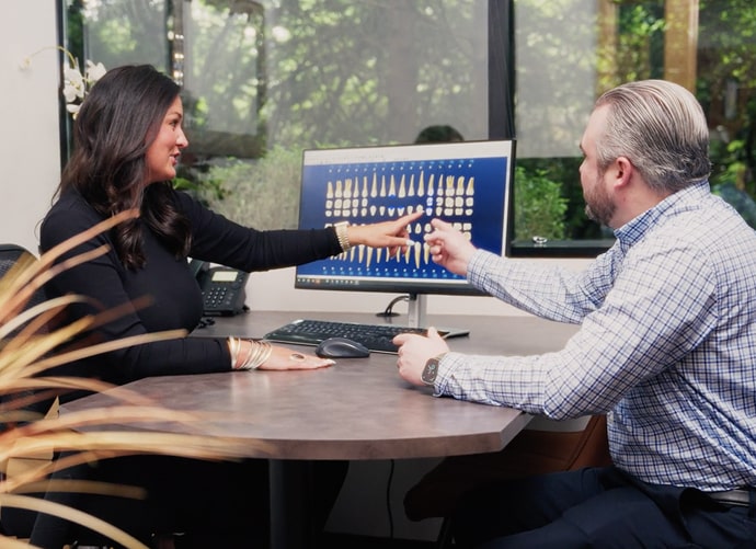 Dr Sherman is shaking hands with his happy patient