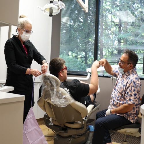 Dr. Ron Sherman with his dental assistant performing dental procedure