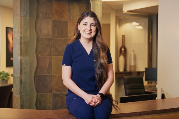 A woman is smiling at the dentist