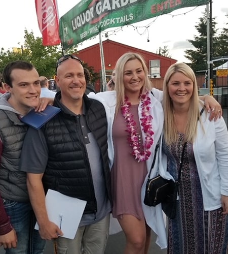 Tracy is smiling with her family